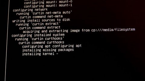 Computer screen shows "installing kernel" and other technical messages during configuration of the Linux operating system.