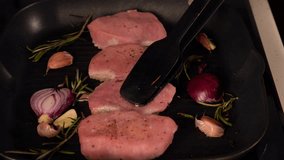 Chef grilling raw pork fillet medallions