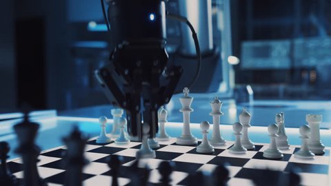 Close Up Shot of a Artificial Intelligence Operating a Futuristic Robotic Arm in a Game of Chess Against a Human. Robot Moves a Pawn. They are in a High Tech Modern Research Laboratory.