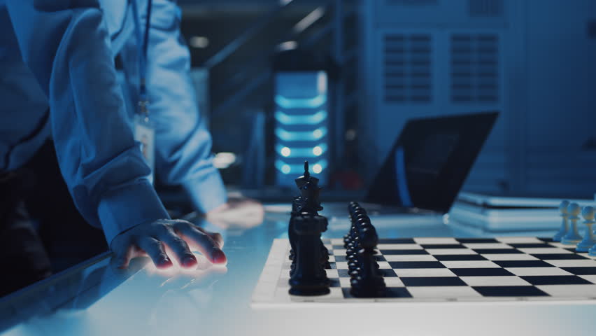 Close Up Shot of a Artificial Intelligence Operating a Futuristic Robotic Arm in a Game of Chess Against a Human. Robot Moves a Pawn. They are in a High Tech Modern Research Laboratory. Royalty-Free Stock Footage #1026241913