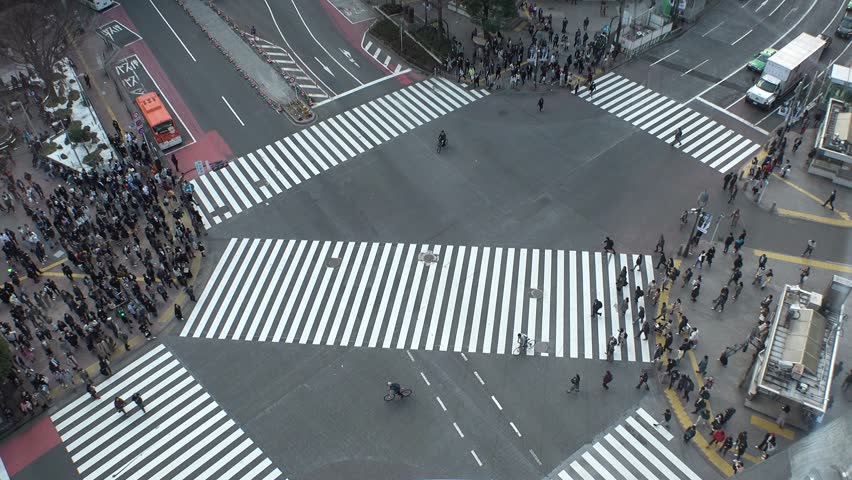 TOKYO, JAPAN: SMARTPHONE and SHIBUYA SCRAMBLE CROSSING background. Image of many people using smartphone.