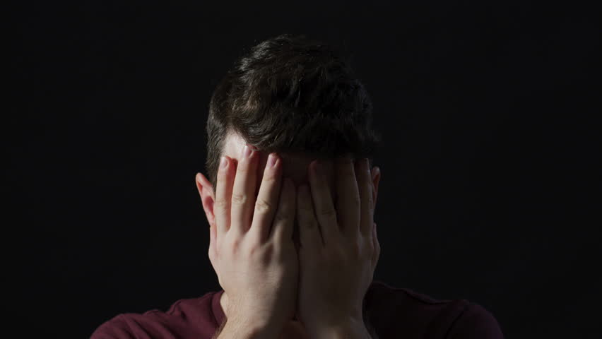 Close up of a tired man massaging his face