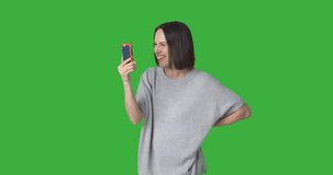 Happy woman doing video chat using mobile phone