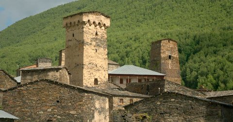 Zoom out from close up  of the stone medieval fortified Svaneti tower houses of  Ushguli, Upper Svaneti, Samegrelo-Zemo Svaneti, Mestia, Georgia.