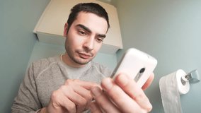 Using a smartphone while on the toilet. Funny humoristic clip.
