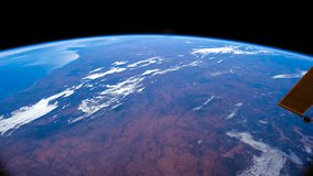 Planet Earth seen from the International Space Station of ocean and continent on the earth behind a dirty window, Time Lapse . Images courtesy of NASA Johnson Space Center. Zoom in motion timelapse.