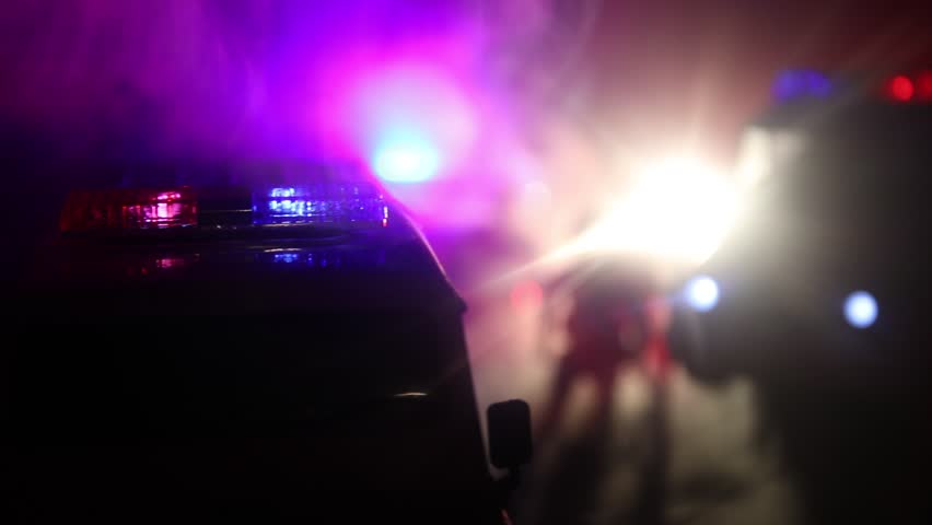 Police cars at night. Police car chasing a car at night with fog background. 911 Emergency response police car speeding to scene of crime. Selective focus | Shutterstock HD Video #1026277148
