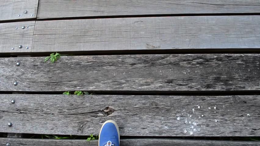 point of view walking on a old broken wooden bridge