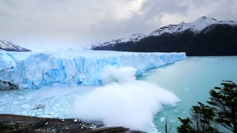 A breathtaking natural phenomenon when chunks of the glacier broke off. Massive glacier break apart.