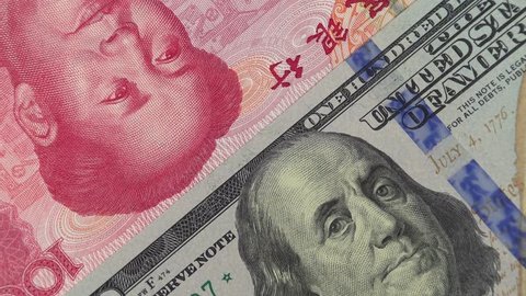 China yuan against US dollar bill rotating. Chinese and USA trade. 4K stock video footage
