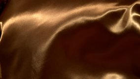 Golden wavy fabric background in super slow motion, 4K - Powered by Shutterstock - Get 15% off with code: PIKWIZARD15