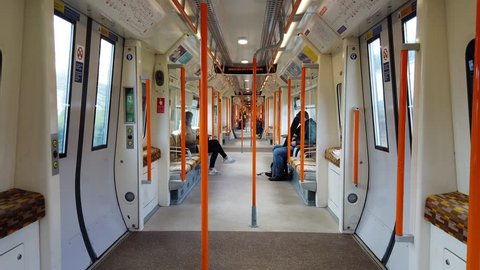 LONDON, UK - MARCH 25, 2019: Passengers sitting inside a moving Overground train operated by TFL in London, UK.