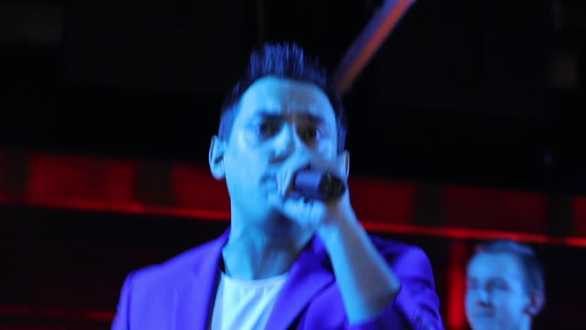 Portrait of singer with microphone and stage lights