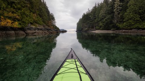 Kayaking on an inflatable kayak in the peaceful ocean by rocky islands near Port Hardy, Vancouver Island, British Columbia, Canada. Still Image Continuous Animation - Cinemagraph