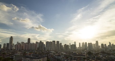 Jakarta, Indonesia: March 24th 2019: Timelapse of sun setting behind tall skyscrapers in Jakarta Central Business District