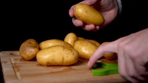 Peeling the skin of a potato in slow motion.