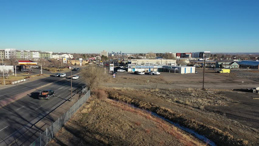 A rising shot above Colfax Blvd as Denver Colorado is seen on the horizon