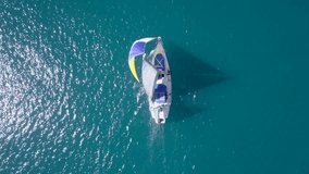 Small sail boat at sea  - Aerial footage.
