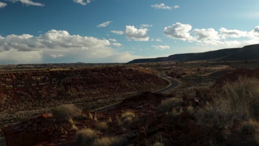 Pan of road and hills in Arizona at Sunset