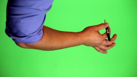 An arm in front of a green screen to be keyed and used at will. Rotate image for best results. Originally used for a few animated whiteboard videos. Black marker writing with pinky out.