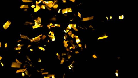 4K Realistic Golden Confetti Party Popper on a Black Background .  Super Slow Motion , Realistic Video Background ... You can use blending mode (screen).