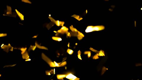 4K Realistic Golden Confetti Party Popper on a Black Background .  Super Slow Motion , Realistic Video Background ... You can use blending mode (screen).