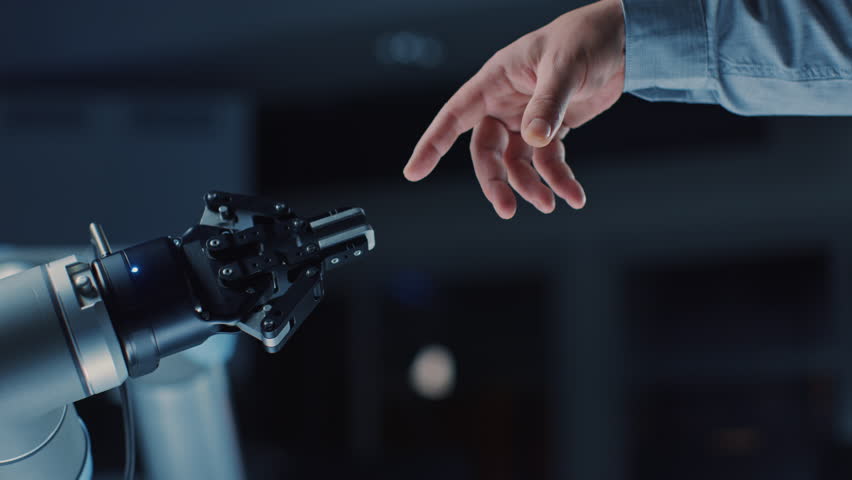 Futuristic Robot Arm Touches Human Hand in Humanity and Artificial Intelligence Unifying Gesture. Conscious Technology Meets Humanity. Concept Inspired by Michelangelo's Creation of Adam | Shutterstock HD Video #1026344132