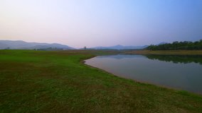 4K video of lake and grass yard landscape in Chiangrai province, Thailand.