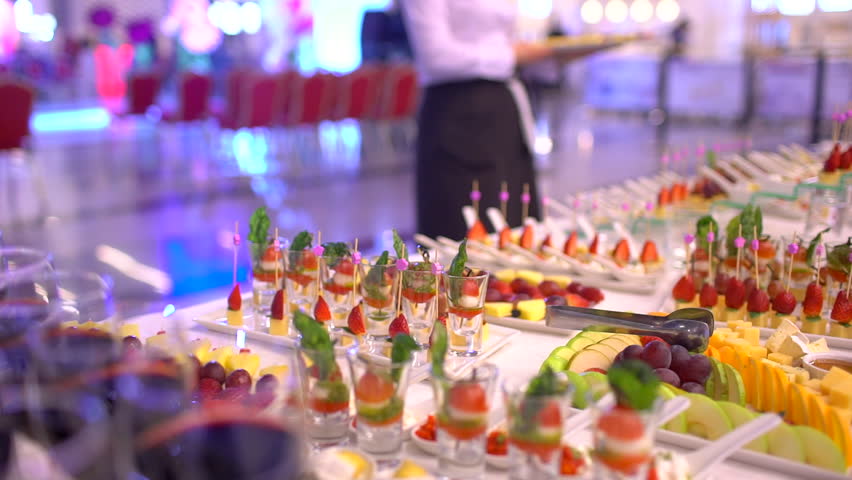 Beautifully decorated catering banquet table with snack canape in restaurant or hotel. catering service bisiness waiter buffet food set in event celebratoin corporate birthday kids party or wedding | Shutterstock HD Video #1026347945