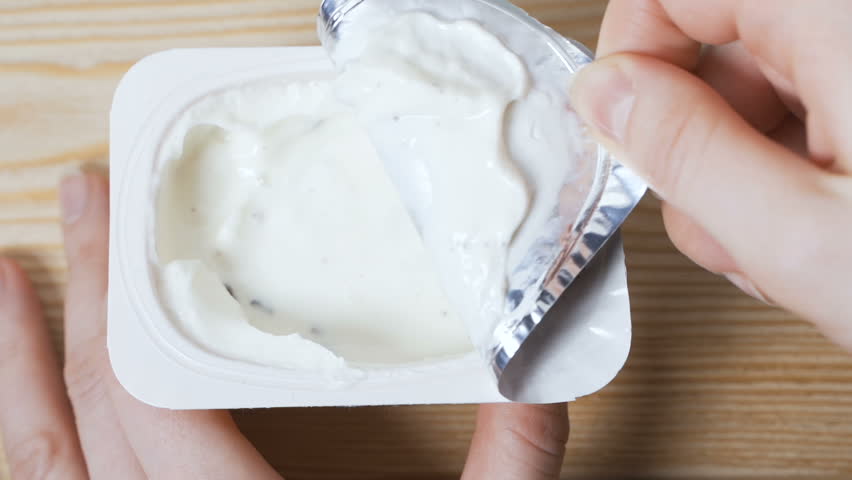 Opening a jar of yogurt | Shutterstock HD Video #1026349070