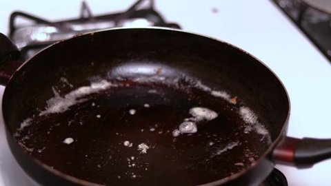 A time lapse or hyperlapse of preparing bacon in a hot frying pan.