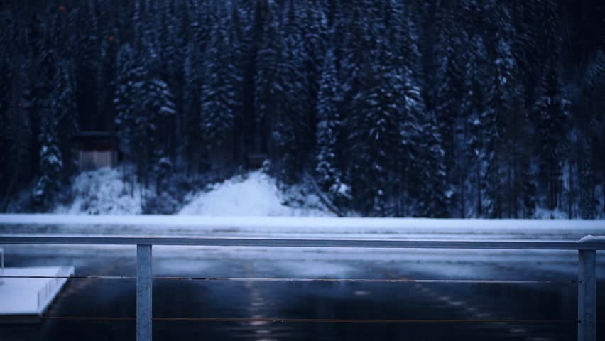 Shot back woman in winter forest near a mountain river stand lifts his hands up picturesque enjoy adventure snow happiness cold vacation outside close up slow motion