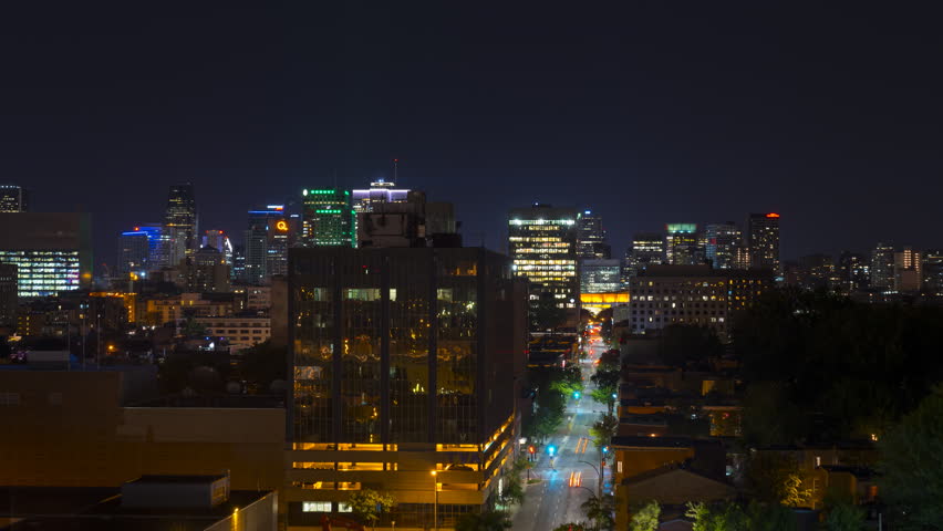 Big city traffic travelling through the downtown core of Montreal Quebec at night. Long exposure light trails show a fast paced city.