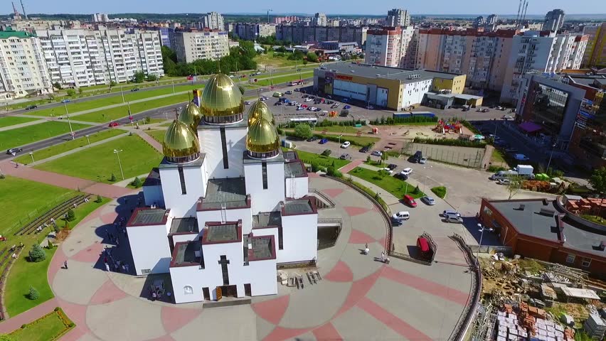 Modern white church with golden domes in dormitory suburb. Top view city. Buildings, transport. Sunny day. Outdoors, catholic, city,  detail, europe, fly,  landmark, morning, neo | Shutterstock HD Video #1026392810