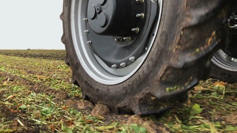 Fisher, MN / United States - 09 17 2018: Close up view of moving tractor tire in field, 9-18-18