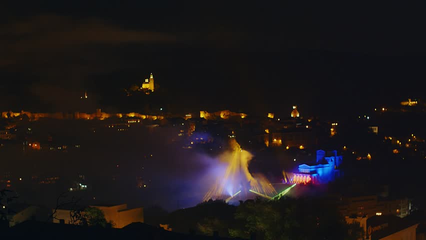 Light and laser show at holiday night over a city, 4k