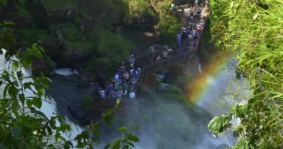 Crowds of Tourists Taking Photos in bridge over the waterfall river Time Lapse, Iguazu Falls