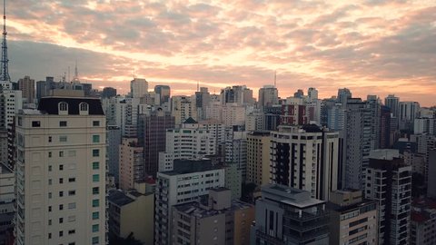 Stunning aerial 4k shot revealing Sao Paolo city centre in sunrise, beautiful orange sky