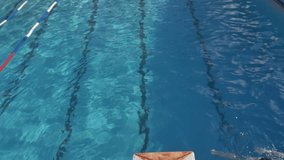 Boy jumping from springboard and diving in Swimming Pool -Slow Motion- For videos about: swimming, pools, summer fun, vacation, getaways, underwater footage, kids, beating the heat, and exercise.
