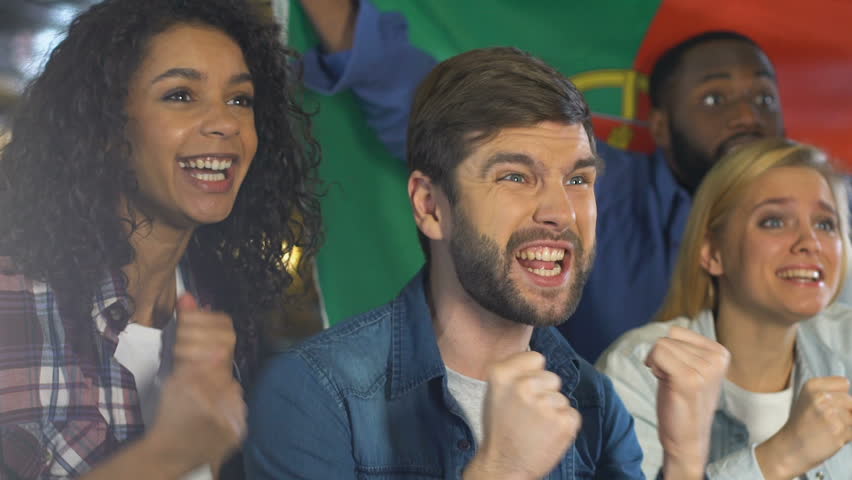 People with Portuguese flag celebrating goal of national football team, league