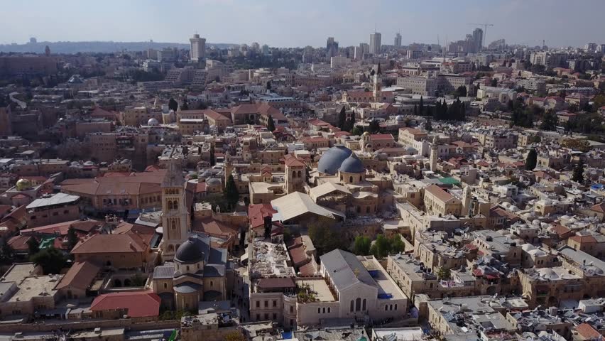 Aerial of Old City Jerusalem and the domes and courtyard of Church of the Holy Sepulchre. Royalty-Free Stock Footage #1026426368