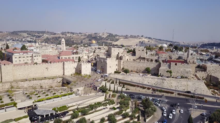 Right side aerial truck shot of the Tower of David Museum, the Jaffa Gate and the entrance to the Mamilla shopping mall, with a beautiful view on the Dome of the Rock and the Temple Mount.