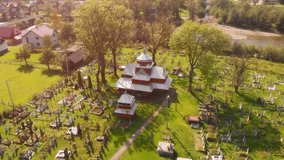 Drone view of an old. orthodox church and cemetery in Yaremche. a rural village on the Prut river in Ukraine.