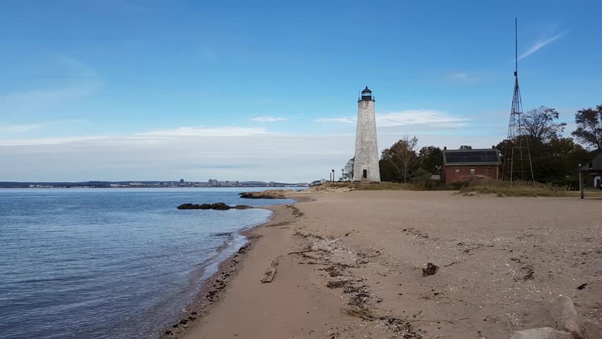 Scenic view on a lighthouse on the Atlantic Ocean Coast during a cloudy morning. Taken in Lighthouse Point Park, New Haven, Connecticut, United States.