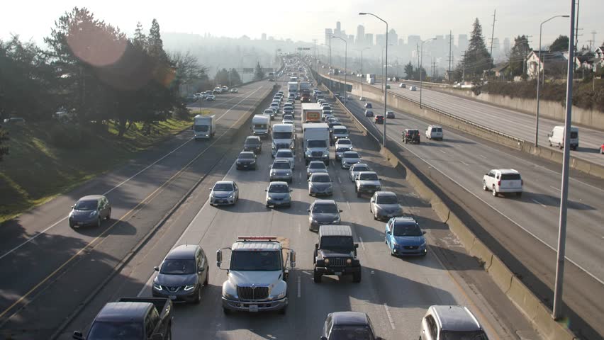 Cars driving through city traffic on I-5 in Seattle. Royalty-Free Stock Footage #1026431285