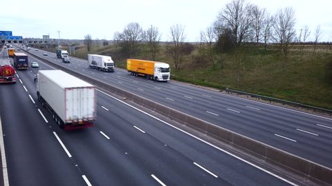 Northamptonshire, UK - March 26 2019 -  Track over road traffic on the M1 smart four lane motorway with no hard shoulder and electronic active traffic management lanes in Northamptonshire England.