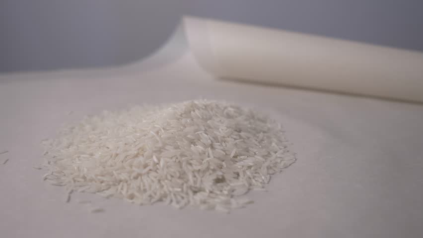 Close-up of white rice on the table. Close-up of camera movement around a handful of white rice. 4K