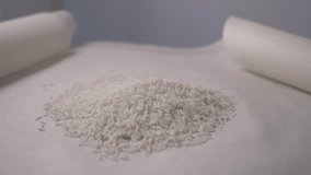 Close-up of white rice on the table. Close-up of camera movement around a handful of white rice. 4K