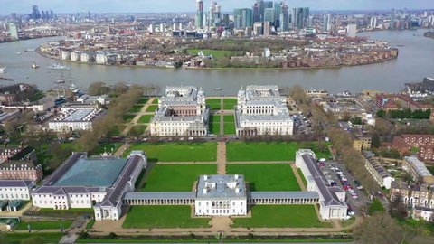Greenwich, London / United Kingdom - March 18 2019: Aerial drone panoramic view of famous Greenwich University and park in the heart of London with unique views to Canary Wharf