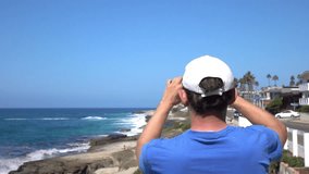 Man recording video of oceanside in California in slow motion 250fps